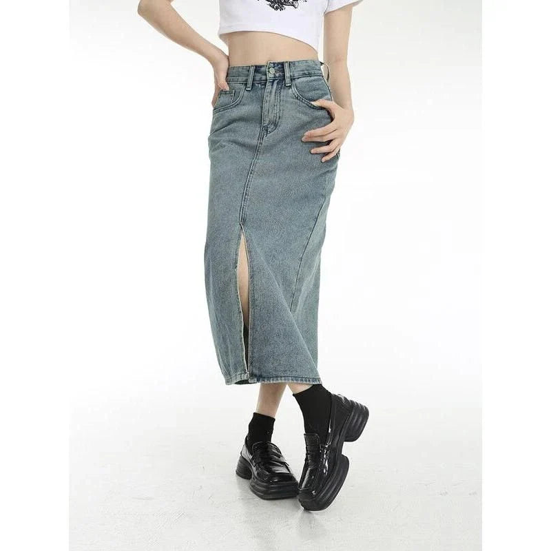 Chic vintage blue denim midi skirt with front slit, featuring a flattering A-line silhouette and stylish distressed details