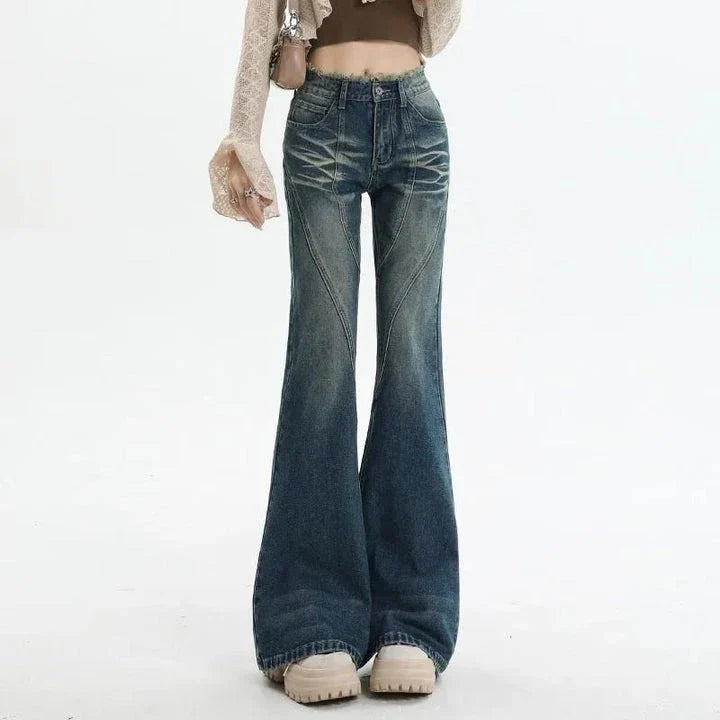 High-waisted flare jeans with a vintage wash, decorative elements, and a flattering silhouette