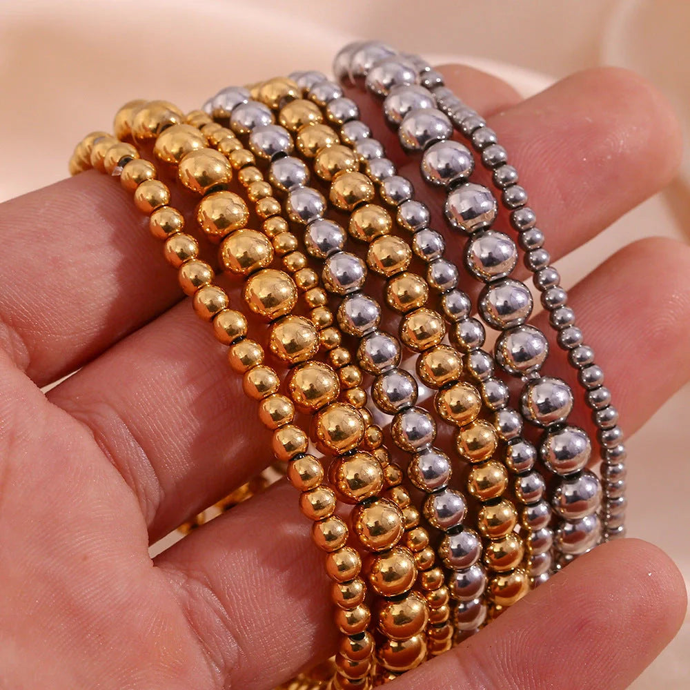 Vintage-inspired stainless steel and 18K plated elastic bead bracelet in a range of sizes and colours