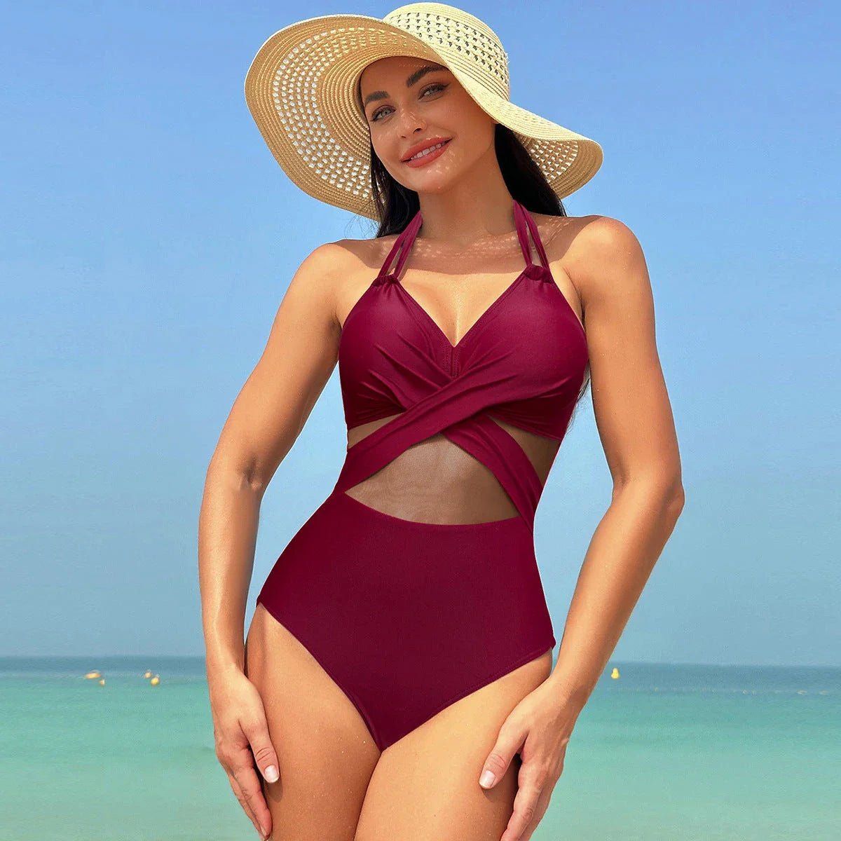 Stylish halter-neck one-piece swimsuit in various colors with cross-strap details and mesh design, perfect for summer beach and vacation wear