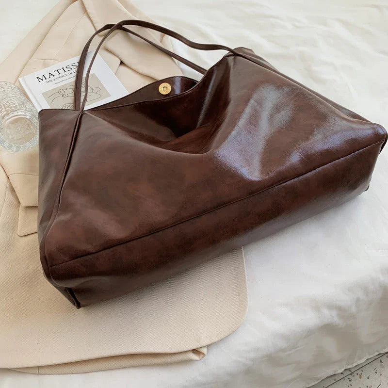Premium faux leather shoulder bag in various colors, featuring a classic silhouette and roomy interior for everyday convenience.