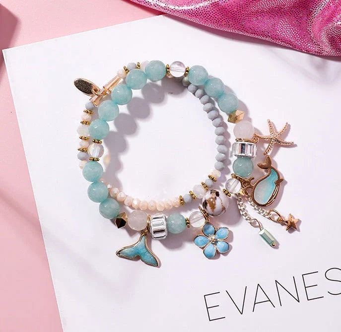 Elegant whale tail bracelet with floral charm in a variety of vibrant colours