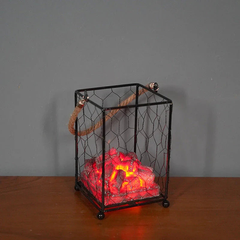 A charcoal-coloured fireplace lamp with a mesmerising LED flame effect, creating a cosy and inviting atmosphere in a living room.