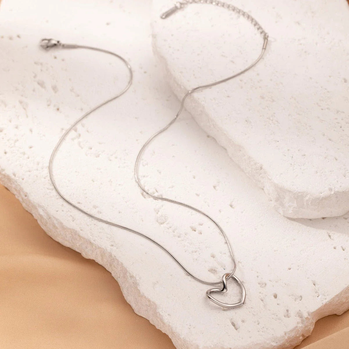 Titanium steel heart pendant necklace in gold and silver finishes, featuring an elegant and adjustable design for a customized fit
