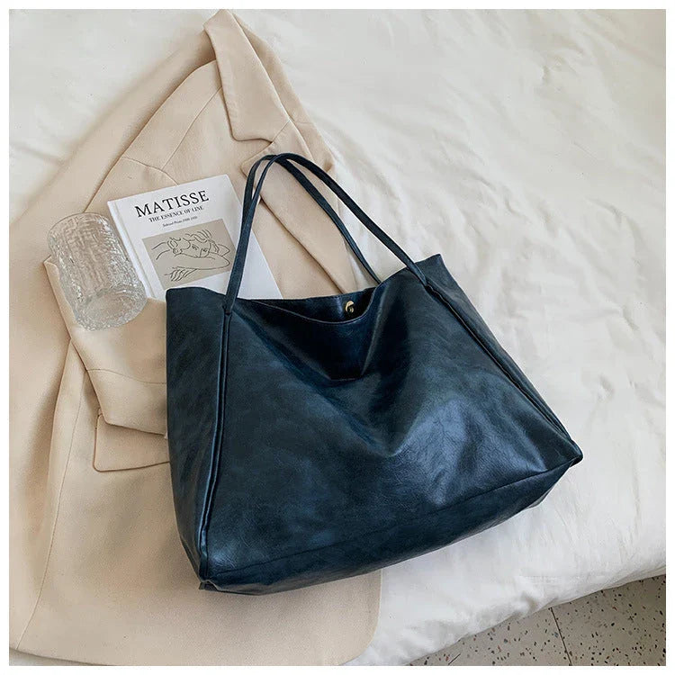 Premium faux leather shoulder bag in various colors, featuring a classic silhouette and roomy interior for everyday convenience.
