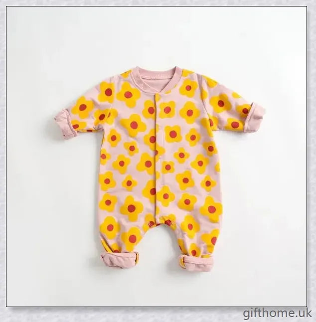 A cosy baby romper with charming cartoon designs, made from soft and breathable cotton fabric.
