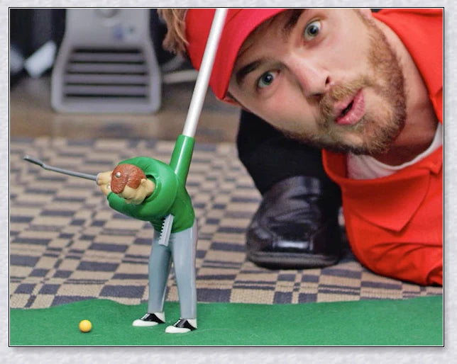 Mini golf game with interchangeable clubs, putting green, and course obstacles for indoor golf practice and entertainment