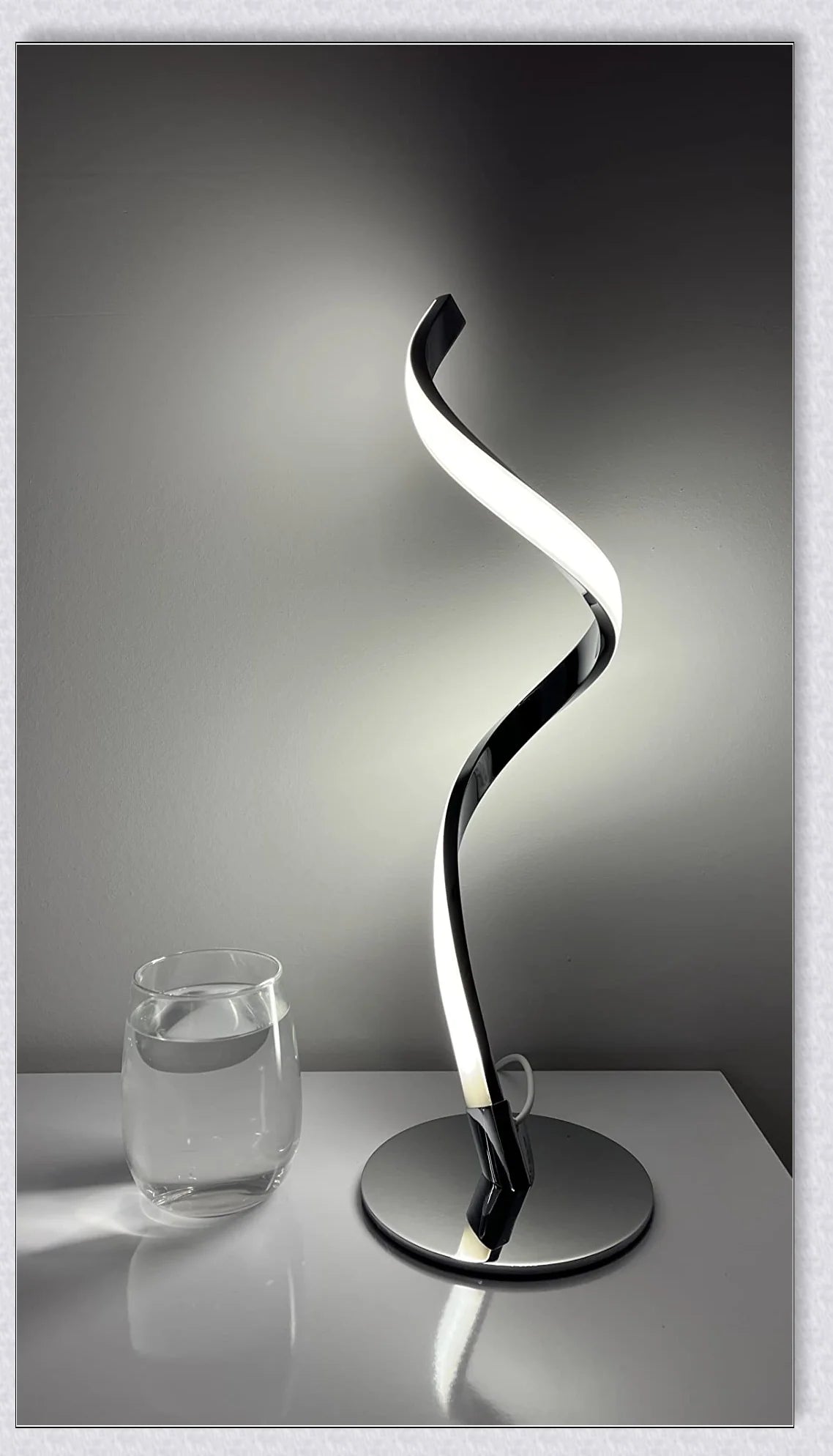 Stylish modern spiral table lamp with adjustable brightness and three colour modes