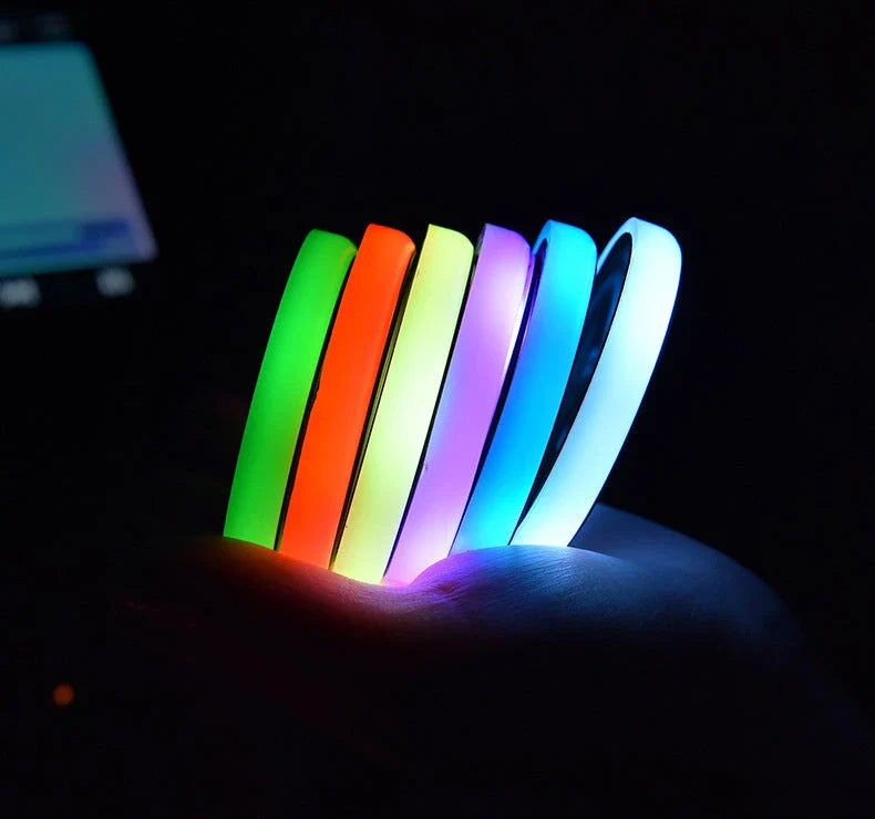 Colorful car cup holder with LED light-up coaster, solar and USB charging, and non-slip surface for ambient lighting in the car