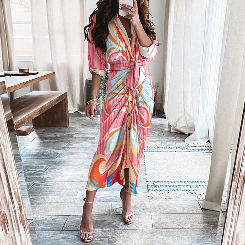 A beautiful floral wrap dress with lace-up detailing, featuring a deep V-neck and full-length skirt for a flattering, elegant look.