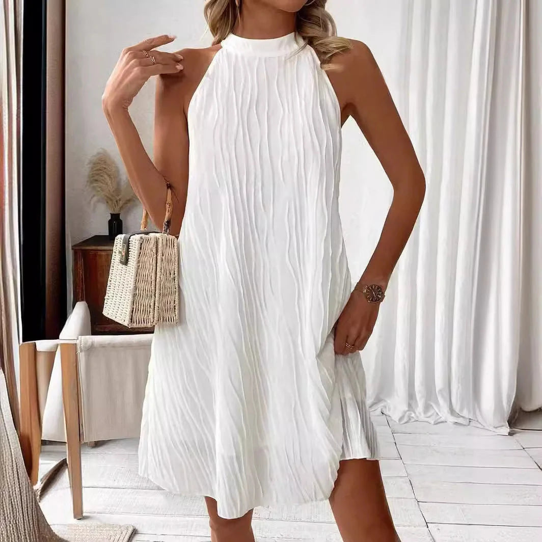 Elegant white backless halter dress with a flattering silhouette and mid-length hemline
