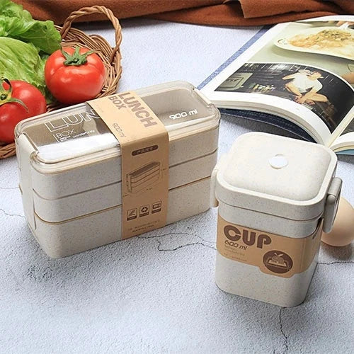 A stylish microwave-safe lunch box with a removable soup mug in various colours, including pink, green, and apricot