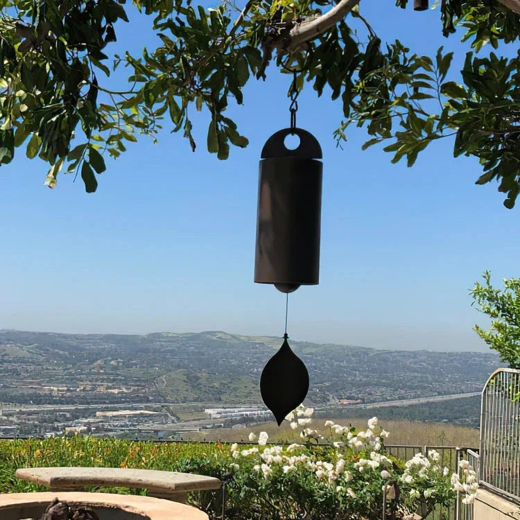 Handcrafted metal wind chimes in black and brown colors, available in small and large sizes, creating a serene outdoor ambiance