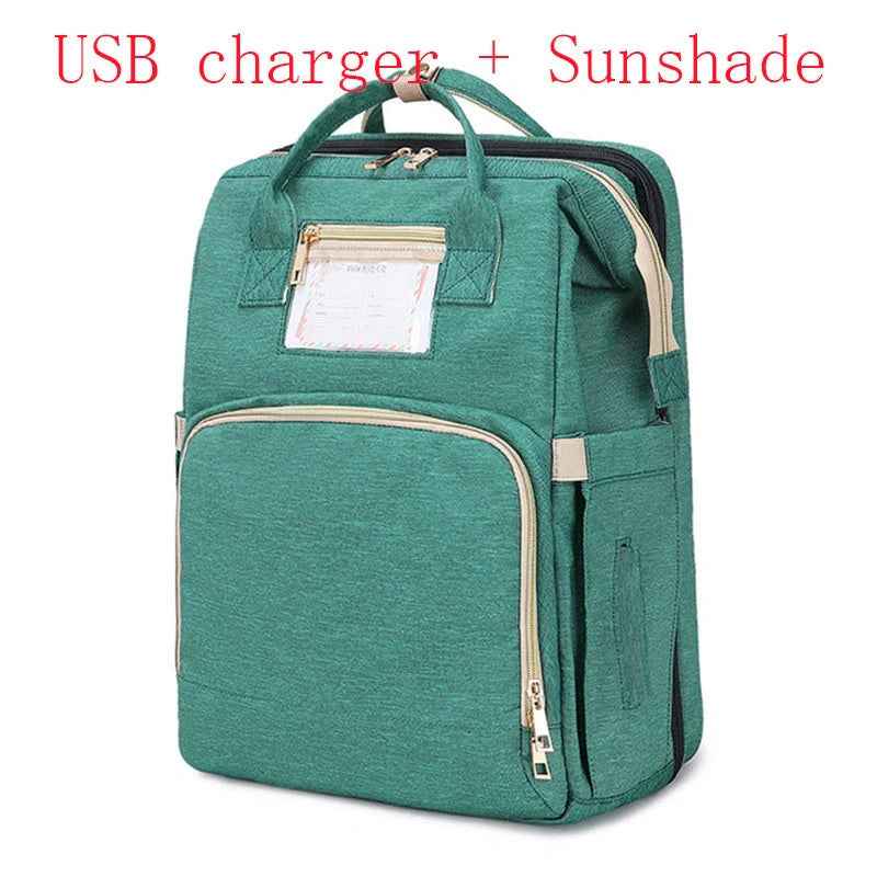 Portable folding crib and mummy bag in green and grey, compact design for baby travel