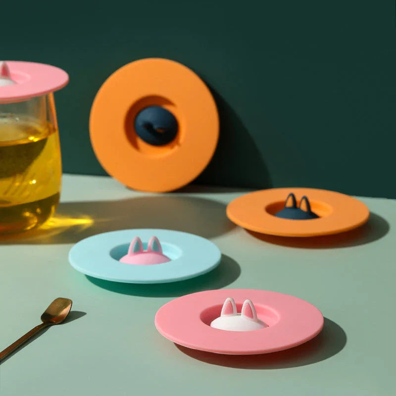 Spill-Proof Cat Ear Silicone Drink Lid in various colors, including pink, orange, and blue