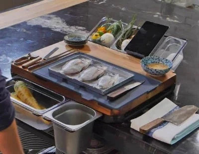 Bamboo cutting board with plastic storage trays for organizing and containing chopped food items