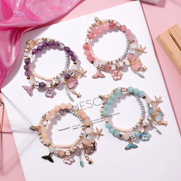 Elegant whale tail bracelet with floral charm in a variety of vibrant colours