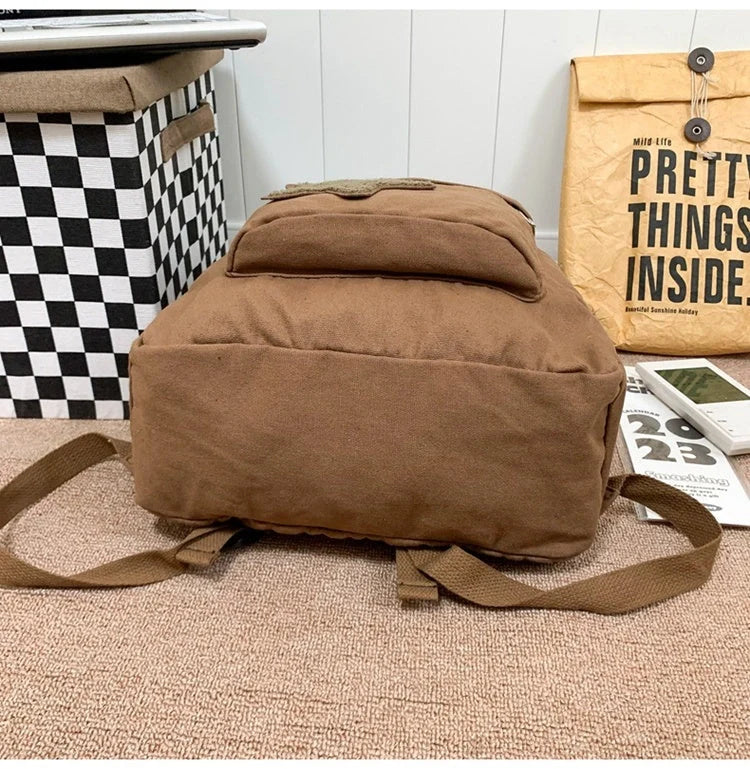 A stylish and durable canvas backpack with geometric patterns, designed for female college students