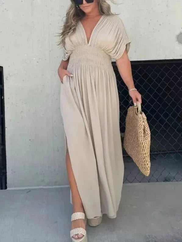 Chic bat-sleeve dress with v-neck, side slit, and elastic waist for comfortable summer style