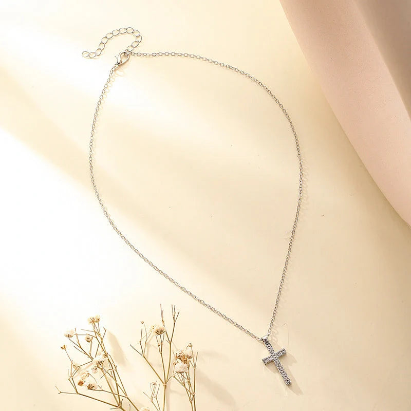 Elegant silver-toned Jesus cross pendant necklace with sparkling artificial gems, showcasing premium British craftsmanship
