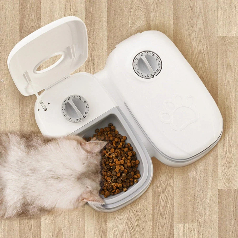 Automatic pet feeder made of durable plastic and stainless steel, designed to dispense consistent meals for cats and dogs without electricity