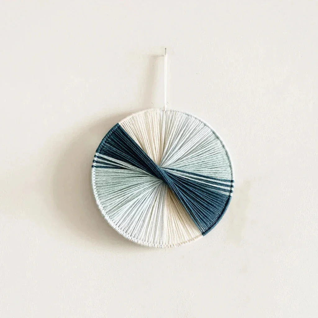 Colourful handmade macramé wall hanging with intricate patterns and vibrant colours, perfect for home decor