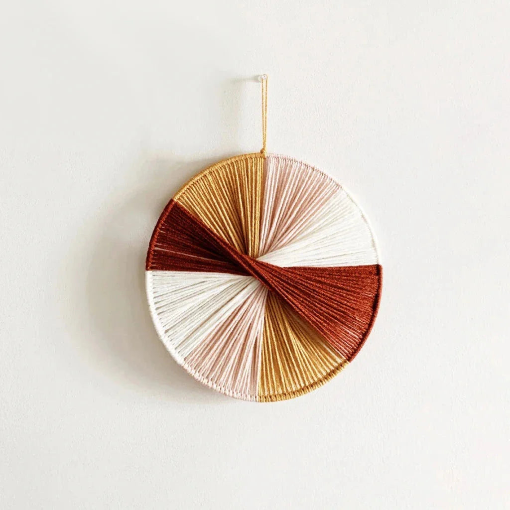 Colourful handmade macramé wall hanging with intricate patterns and vibrant colours, perfect for home decor