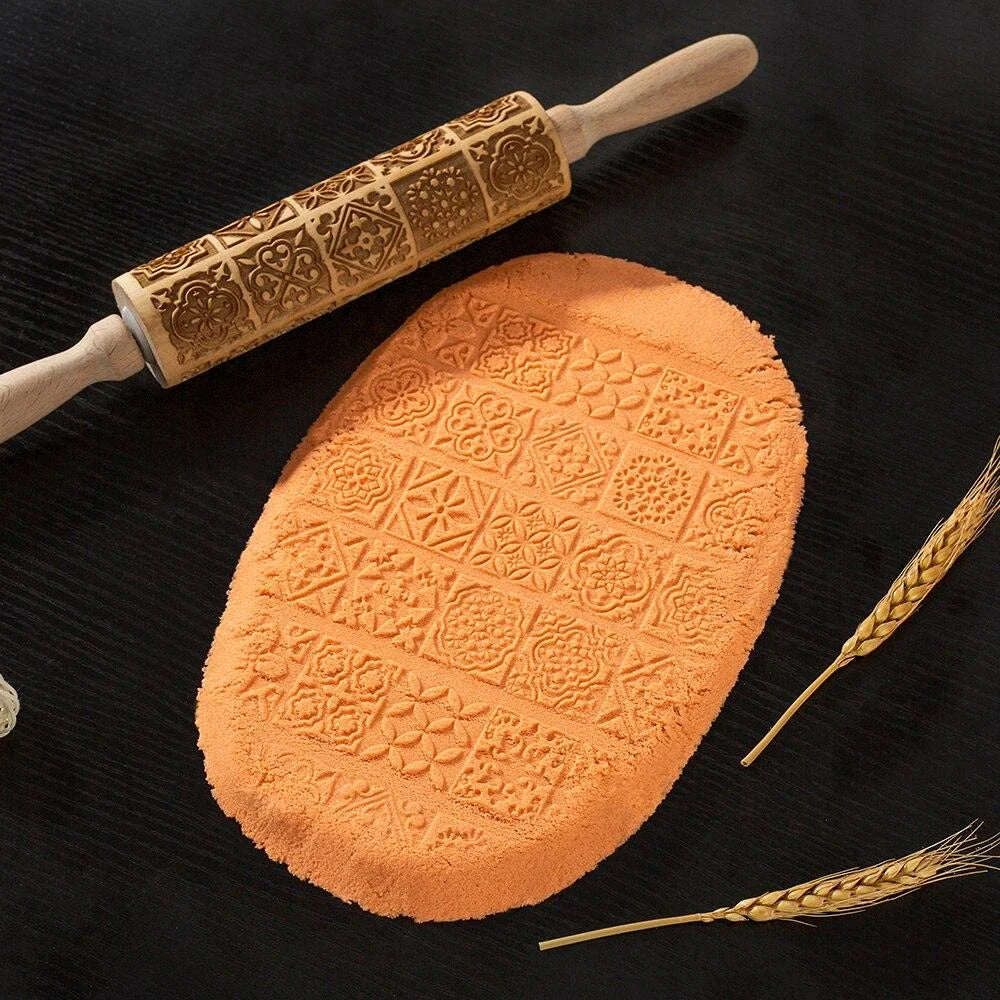 Embossed rolling pin made of natural wood with intricate designs for creating textured baked goods