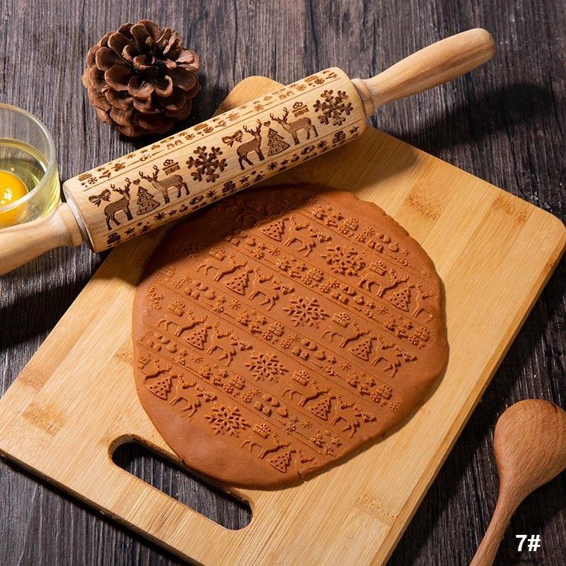 Embossed rolling pin made of natural wood with intricate designs for creating textured baked goods