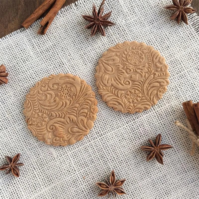 Embossed rolling pin made of natural wood with intricate designs for creating textured baked goods