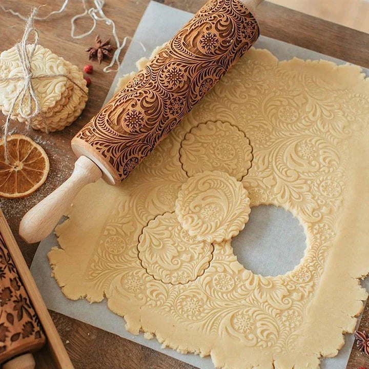Embossed rolling pin made of natural wood with intricate designs for creating textured baked goods