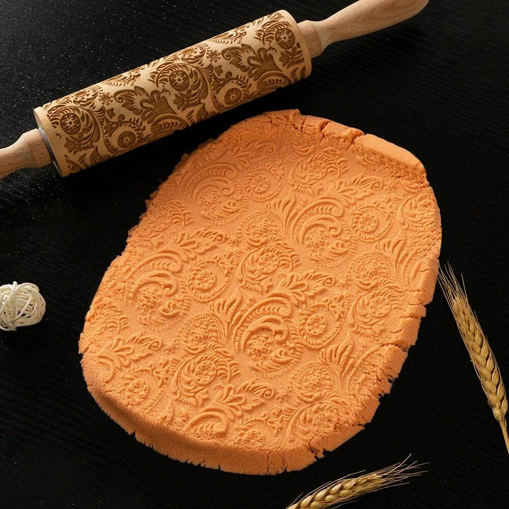 Embossed rolling pin made of natural wood with intricate designs for creating textured baked goods