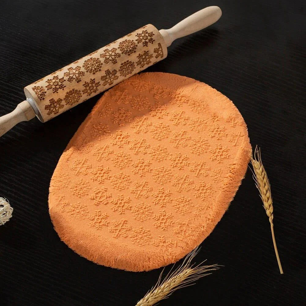 Embossed rolling pin made of natural wood with intricate designs for creating textured baked goods