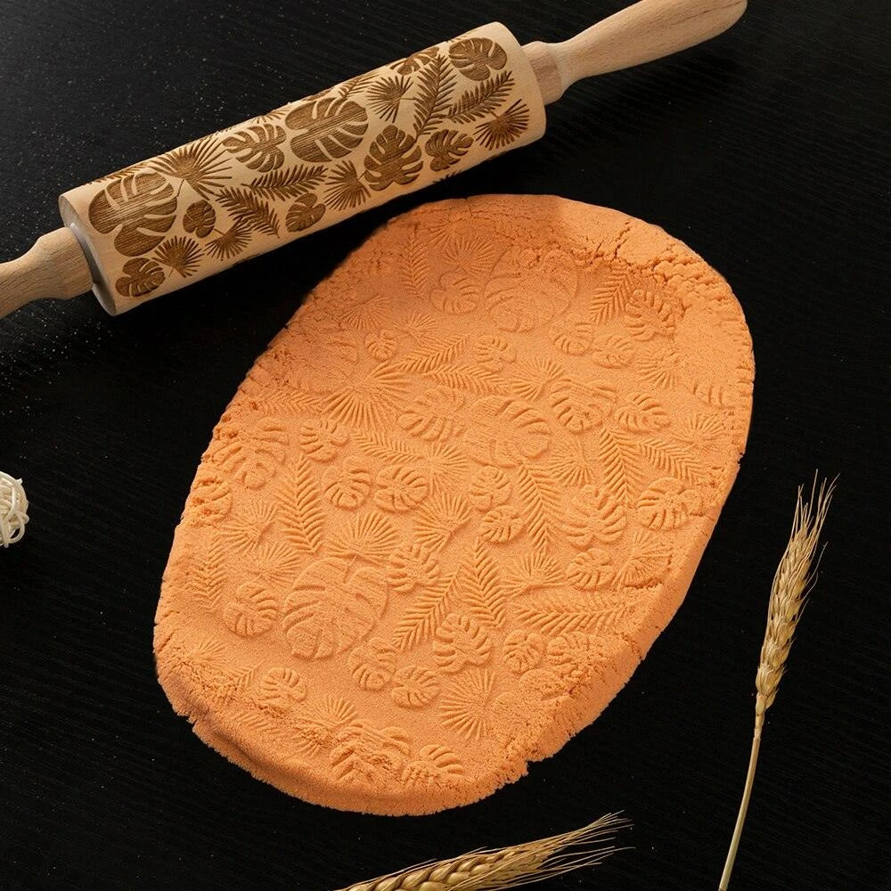 Embossed rolling pin made of natural wood with intricate designs for creating textured baked goods