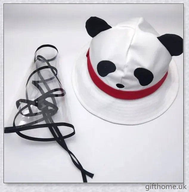 A baby wearing a cotton sun hat with a panda print design, offering protection from the sun and spray.