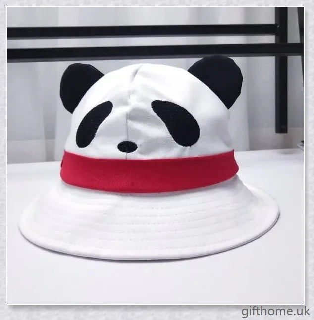 A baby wearing a cotton sun hat with a panda print design, offering protection from the sun and spray.