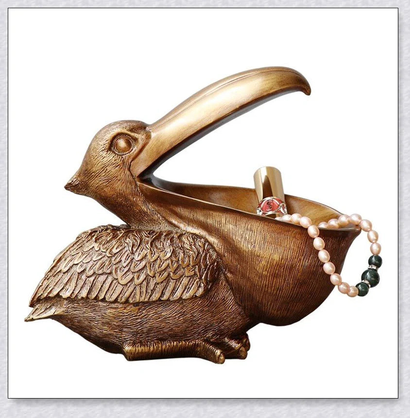 Pelican Storage Figurine, a high-quality resin sculpture with an open mouth design for practical storage and elegant décor.