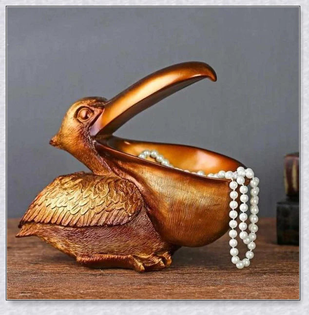 Pelican Storage Figurine, a high-quality resin sculpture with an open mouth design for practical storage and elegant décor.