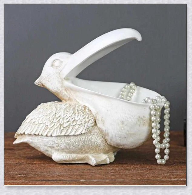 Pelican Storage Figurine, a high-quality resin sculpture with an open mouth design for practical storage and elegant décor.