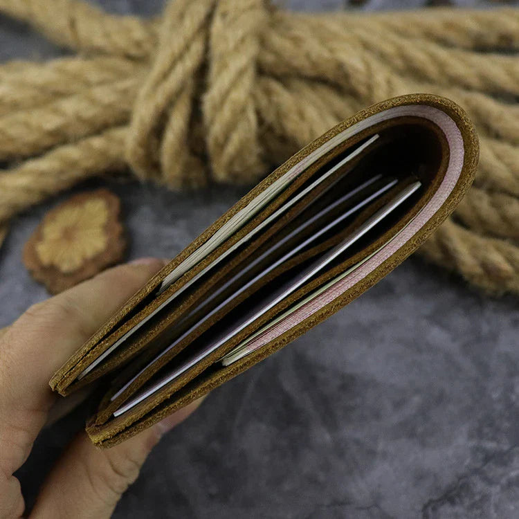 A close-up view of a premium leather wallet in a light brown colour, featuring a single money clip and multiple card slots for organised storage of essentials.