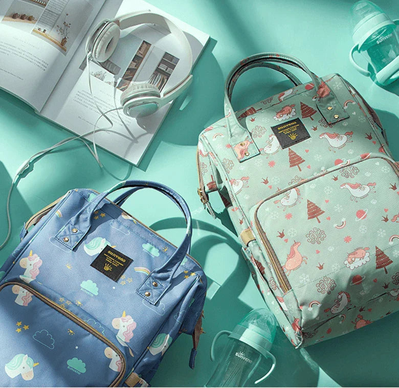 Multi-purpose large capacity mummy bag in blue, with a sleek backpack-inspired design and ample storage for parenting essentials