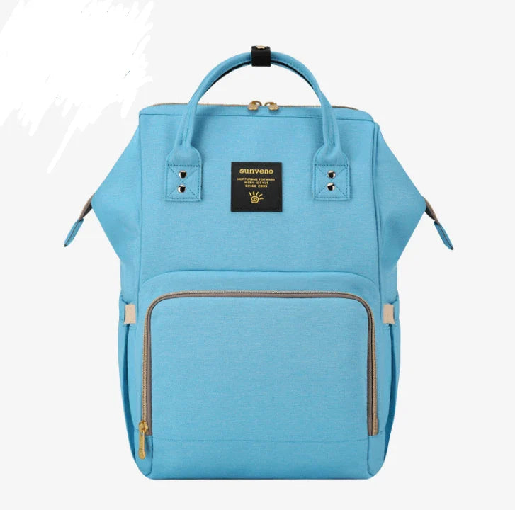 Multi-purpose large capacity mummy bag in blue, with a sleek backpack-inspired design and ample storage for parenting essentials