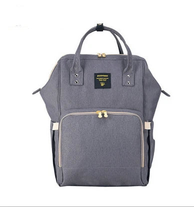 Multi-purpose large capacity mummy bag in blue, with a sleek backpack-inspired design and ample storage for parenting essentials