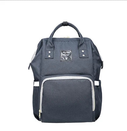 Multi-purpose large capacity mummy bag in blue, with a sleek backpack-inspired design and ample storage for parenting essentials