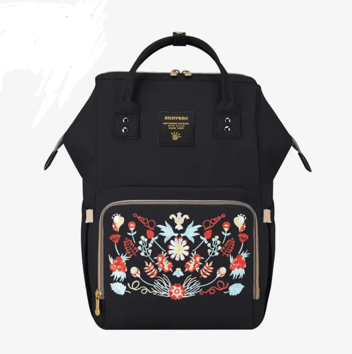 Multi-purpose large capacity mummy bag in blue, with a sleek backpack-inspired design and ample storage for parenting essentials