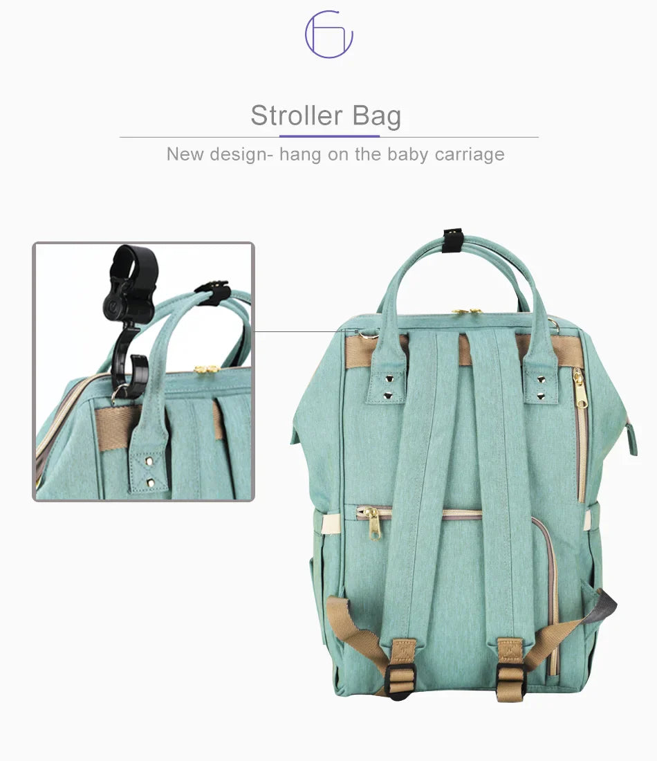 Multi-purpose large capacity mummy bag in blue, with a sleek backpack-inspired design and ample storage for parenting essentials