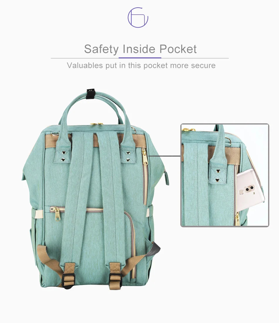 Multi-purpose large capacity mummy bag in blue, with a sleek backpack-inspired design and ample storage for parenting essentials