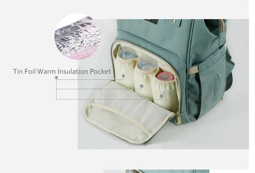 Multi-purpose large capacity mummy bag in blue, with a sleek backpack-inspired design and ample storage for parenting essentials