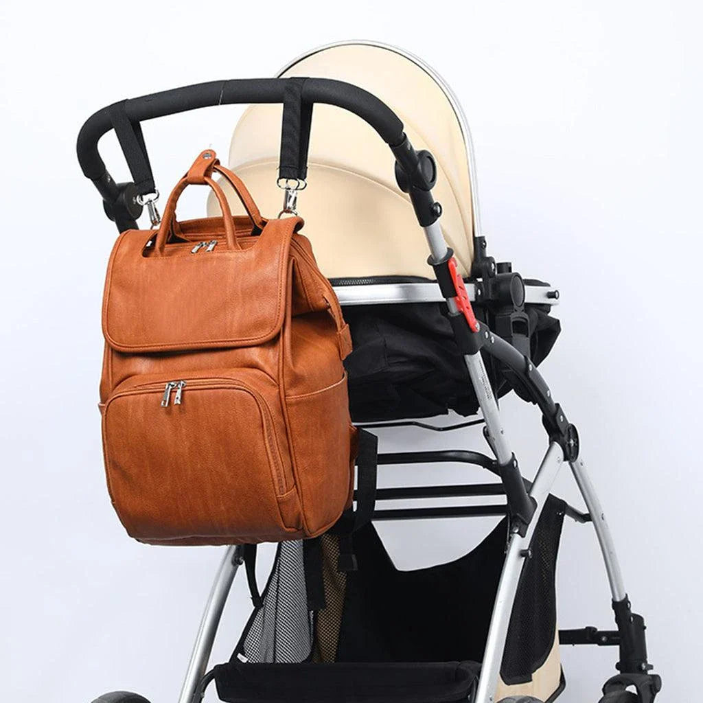 PU Leather Diaper Bag Backpack in Black, featuring side pocket, anti-theft compartment, and stroller straps