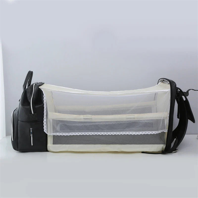 PU Leather Diaper Bag Backpack in Black, featuring side pocket, anti-theft compartment, and stroller straps
